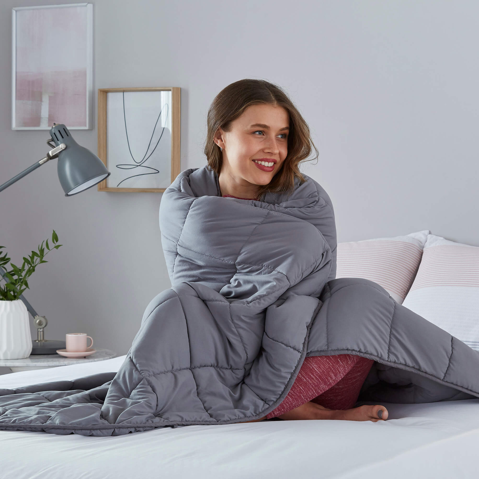 A woman wrapped in a weighted blanket