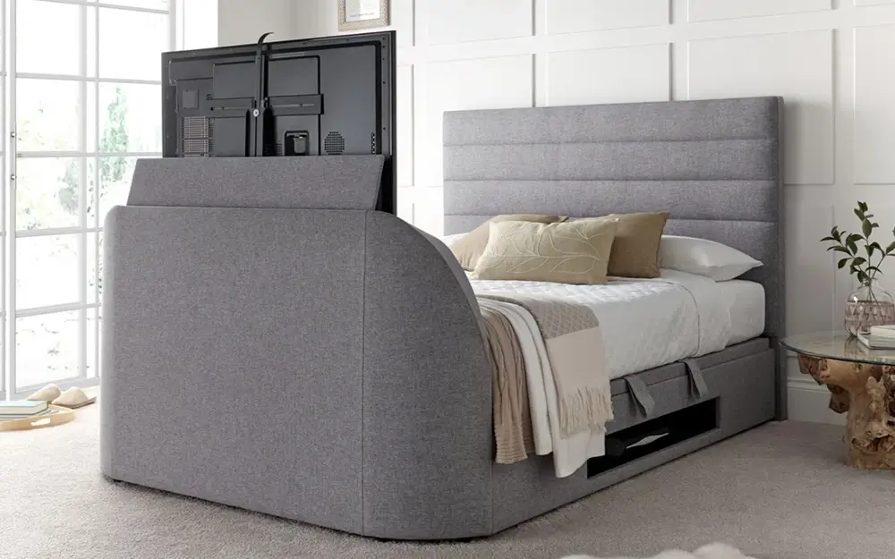 The Novo Aporo TV Ottoman Bed Frame in dark grey in a white, minimalist bedroom.