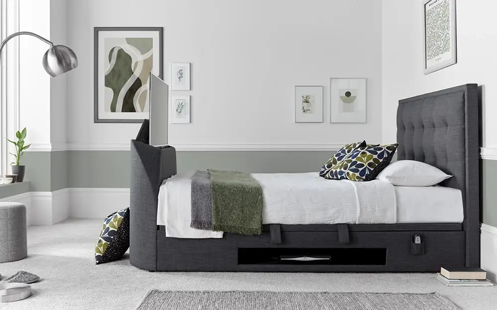 The Novo Falcini TV Ottoman Bed Frame in dark grey in a minimalist, white bedroom.