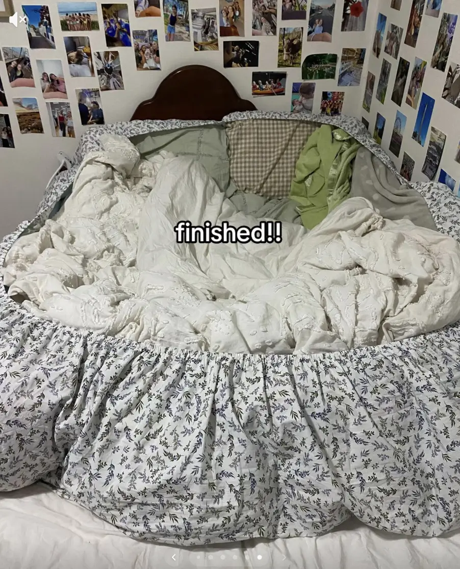 A 'potato bed' from the TikTok trend. This shows a a fitted sheet stuffed with blankets, pillows and other cosy accessories arranged and nested to resemble the look of an open jacket potato,
